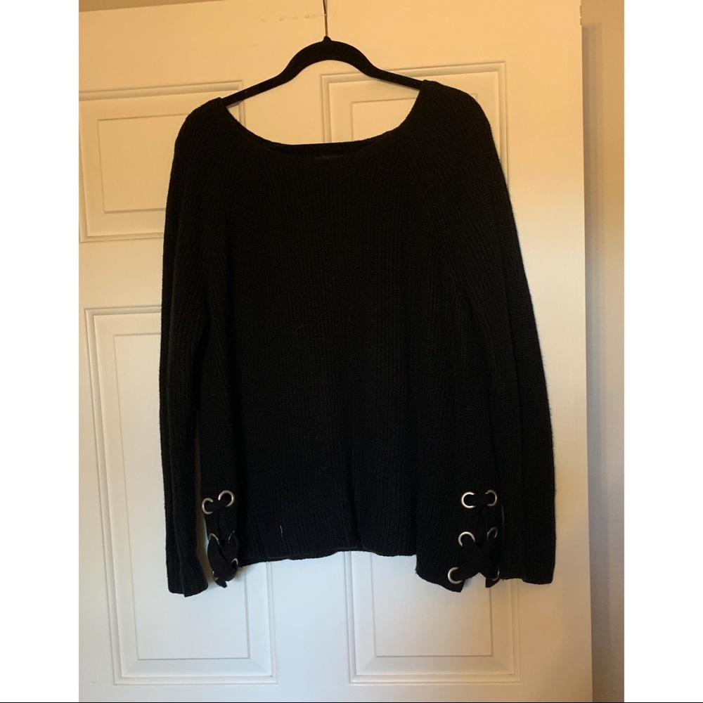Black sweater with metal grommets